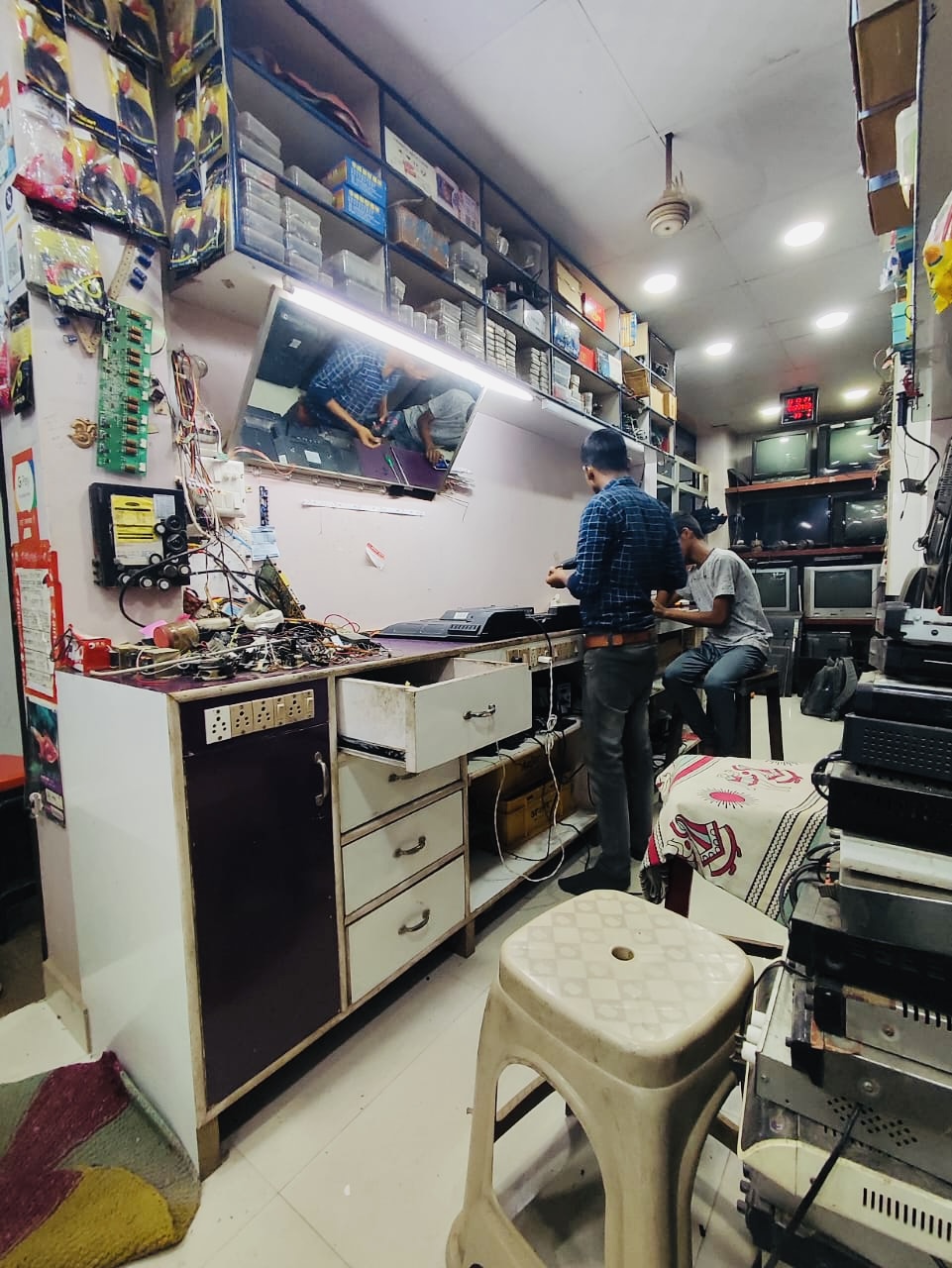 Technicians working at the television repair bench